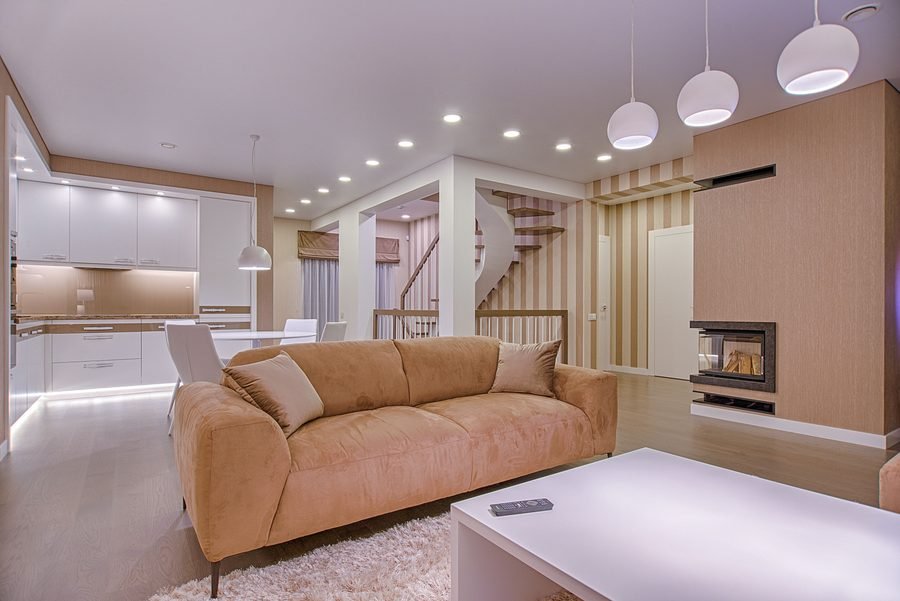 Residential living space with layered recessed, pendant, and accent lighting design
